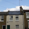 an external picture of a completed loft conversion in a london street